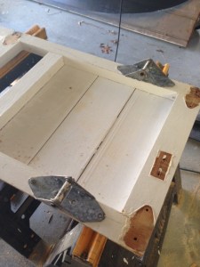 End panel - siding already attached and now hinges added - note that the bottom thick cross member had to be added as well